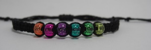 Handmade knotted macrame adjustable bracelet made with black bamboo cord and high quality sparkly pony beads.